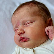 Sunny is registered to the contest to win money with this photo: baby, newborn, sleeping, close_up, face, infant, skin, peaceful, fist, cute, soft, white_background, clothing, portrait, child, resting, peace, small, fresh, newborn_baby