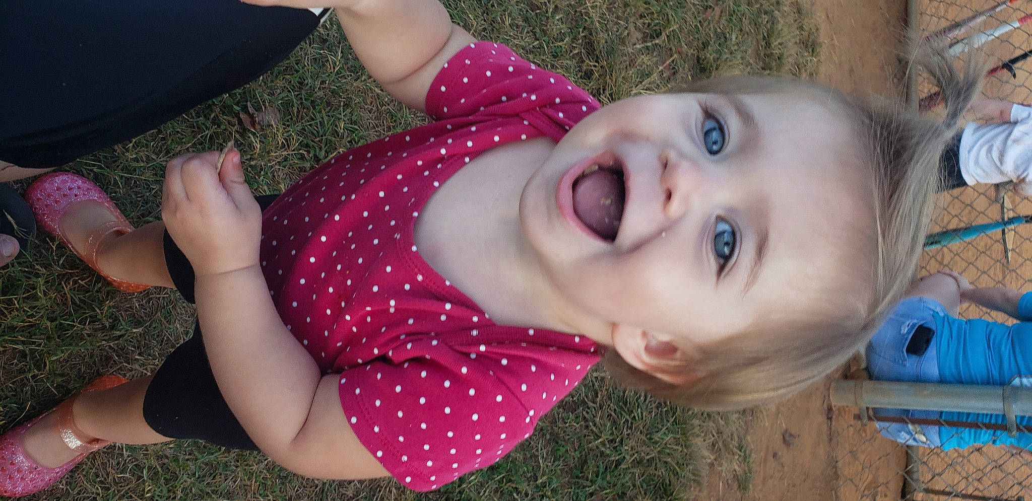Paisley joined the competition — help win amazing prizes! baby_toddler_clothing, brown_hair, child, eyelash, fun, grass, happy, lip, mouth, nose, pattern, person, pink, plaid, plant, smile, spring, summer, tartan, toddler