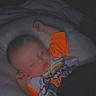 Jaxson joined the competition — help win amazing prizes! baby, sleeping, pillow, child, toddler, bed, blanket, orange_shirt, cartoon_graphic, peaceful, indoors, dark, cozy, resting, cute, infant, person, face, head, night