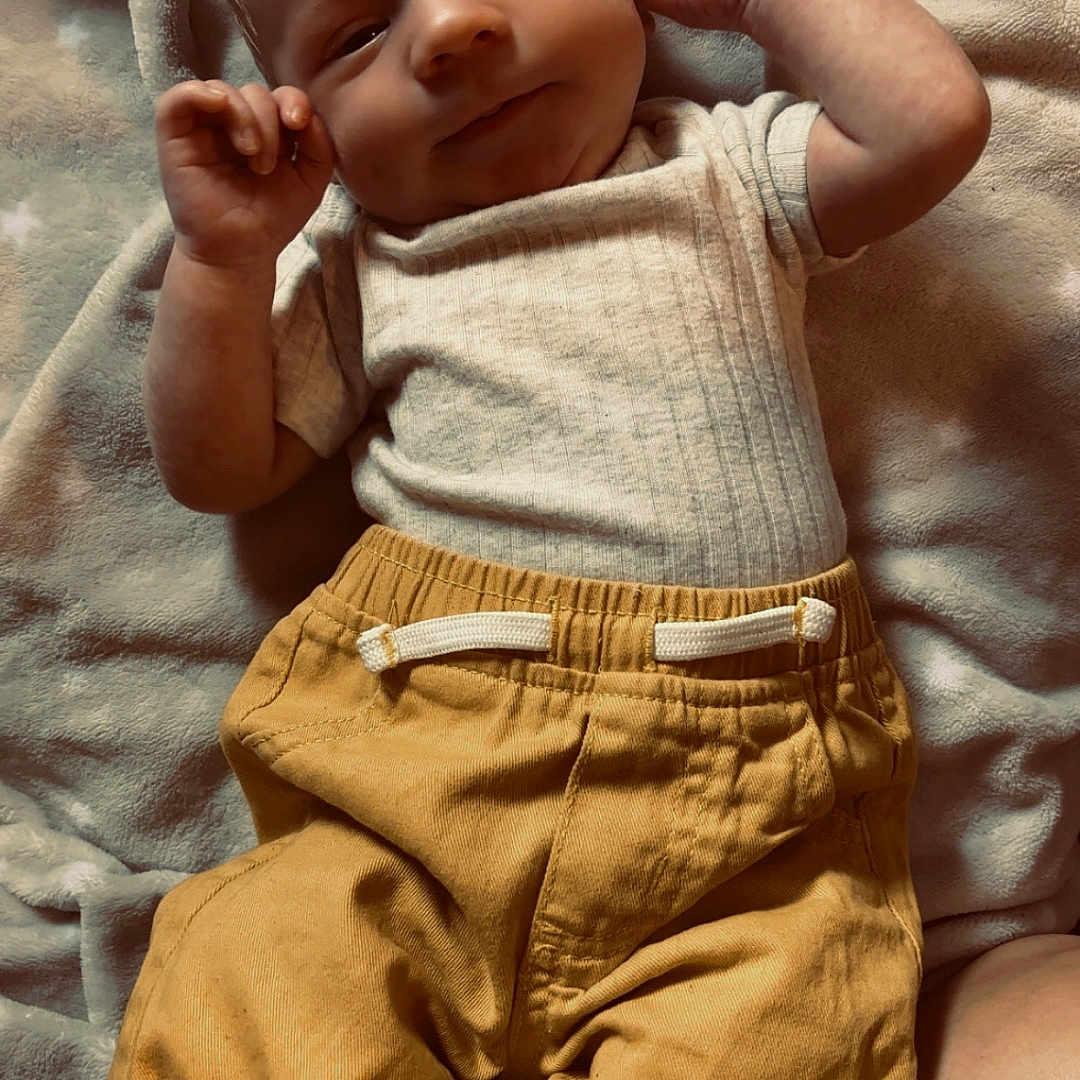 Lachlan joined the competition — help win amazing prizes! baby, blanket, child, clothing, comfort, cute, face, hand, indoors, infant, lying_down, pants, peaceful, portrait, relaxed, shirt, skin, smiling, soft_texture, young