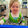 toddler, child, shopping_cart, walmart, buzz_lightyear, green_clothing, pharmacy, store, shopping, smile, blue_eyes, indoor, person, seat_belt, casual_clothing, retail, young_child, cute, happy, portrait