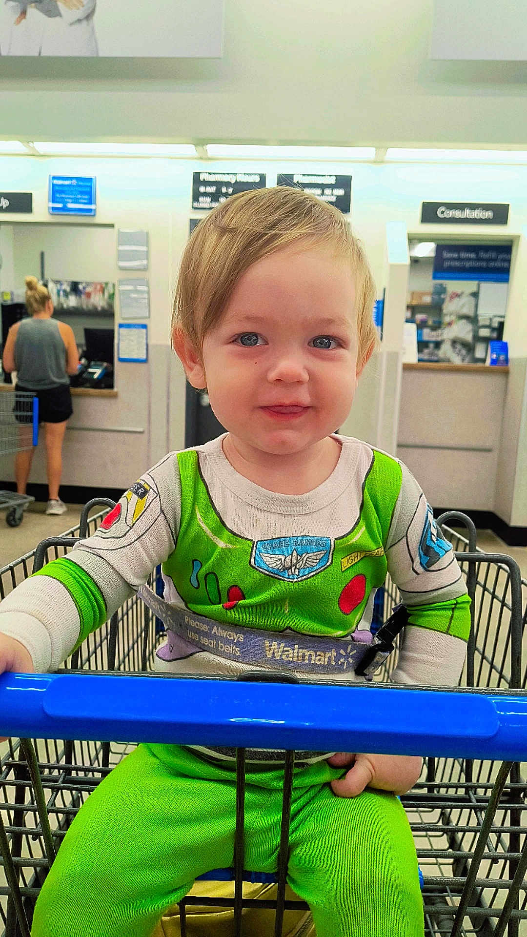 Austin joined the competition — help win amazing prizes! toddler, child, shopping_cart, walmart, buzz_lightyear, green_clothing, pharmacy, store, shopping, smile, blue_eyes, indoor, person, seat_belt, casual_clothing, retail, young_child, cute, happy, portrait