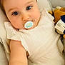 Azura participe au concours pour gagner de l'argent avec cette photo : adorable, baby, baby_carrier, blue_eyes, child, close_up, comfort, cushion, cute, expression, face, indoors, infant, pacifier, portrait, seat, skin, soft_toy, white_outfit, young_child