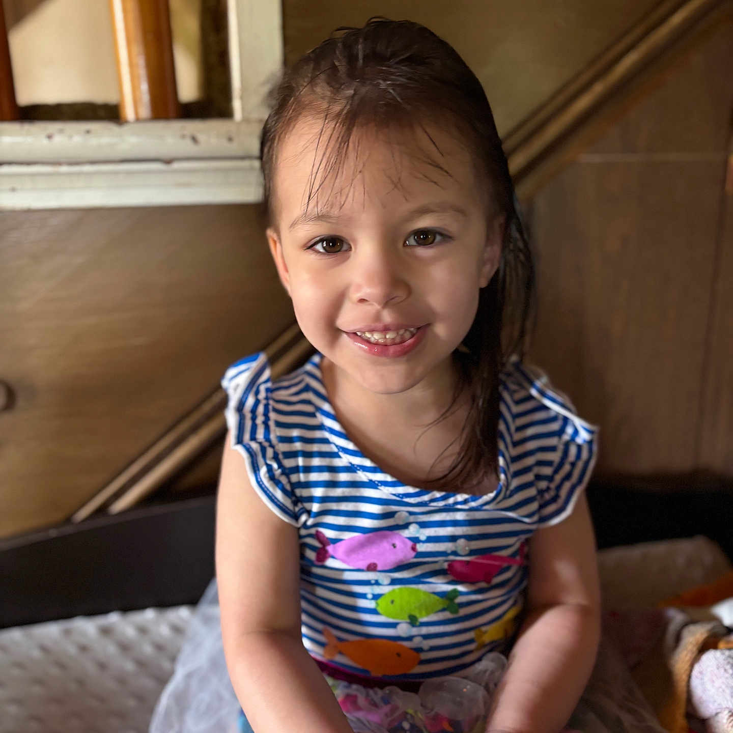 Amelia joined the competition — help win amazing prizes! background, child, clothing, colorful_clothing, cute, dress, face, fish_pattern, furniture, girl, hair, happy, indoor, person, playful, portrait, sitting, smiling, toddler, wood