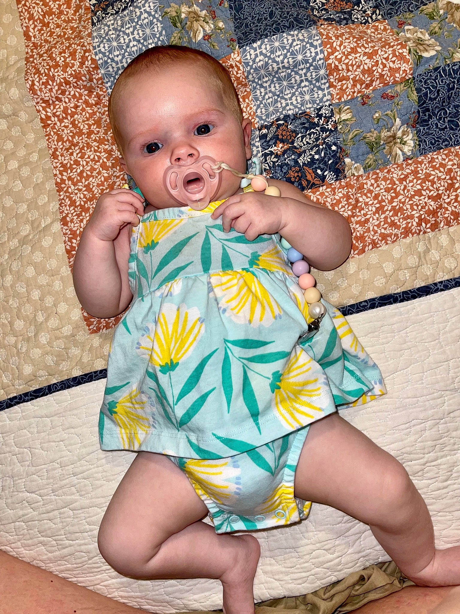 Kenzlee is registered to the contest to win money with this photo: baby, baby_toddler_clothing, cheek, child, day_dress, dress, eye, happy, head, human_leg, iris, nail, one_piece_garment, pattern, person, pink, sitting, skin, textile, thigh