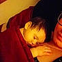 Raffael joined the competition — help win amazing prizes! baby, sleeping, blanket, red_blanket, hand, face, person, adult, glasses, resting, indoor, closeup, cozy, warm_lighting, comfort, toddler, parent, snuggling, peaceful, portrait