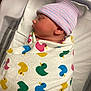 Ronin joined the competition — help win amazing prizes! newborn, baby, swaddled, blanket, duck_pattern, hat, striped_hat, sleeping, infant, hospital, bassinet, resting, cozy, cute, child, person, portrait, side_profile, indoors, soft
