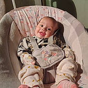 Oakley joined the competition — help win amazing prizes! baby, infant, smiling, baby_rocker, floral_pattern, pink_socks, cozy, cute_outfit, happy, indoors, soft_lighting, child, face, person, seated, baby_clothes, comfort, home, small_child, adorable