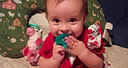 Oakley joined the competition — help win amazing prizes! baby, bed, child, clothing, cow, cute, fabric, face, floral_dress, green, hand, indoors, pacifier, person, pillow, pink, playful, red, smiling, toy