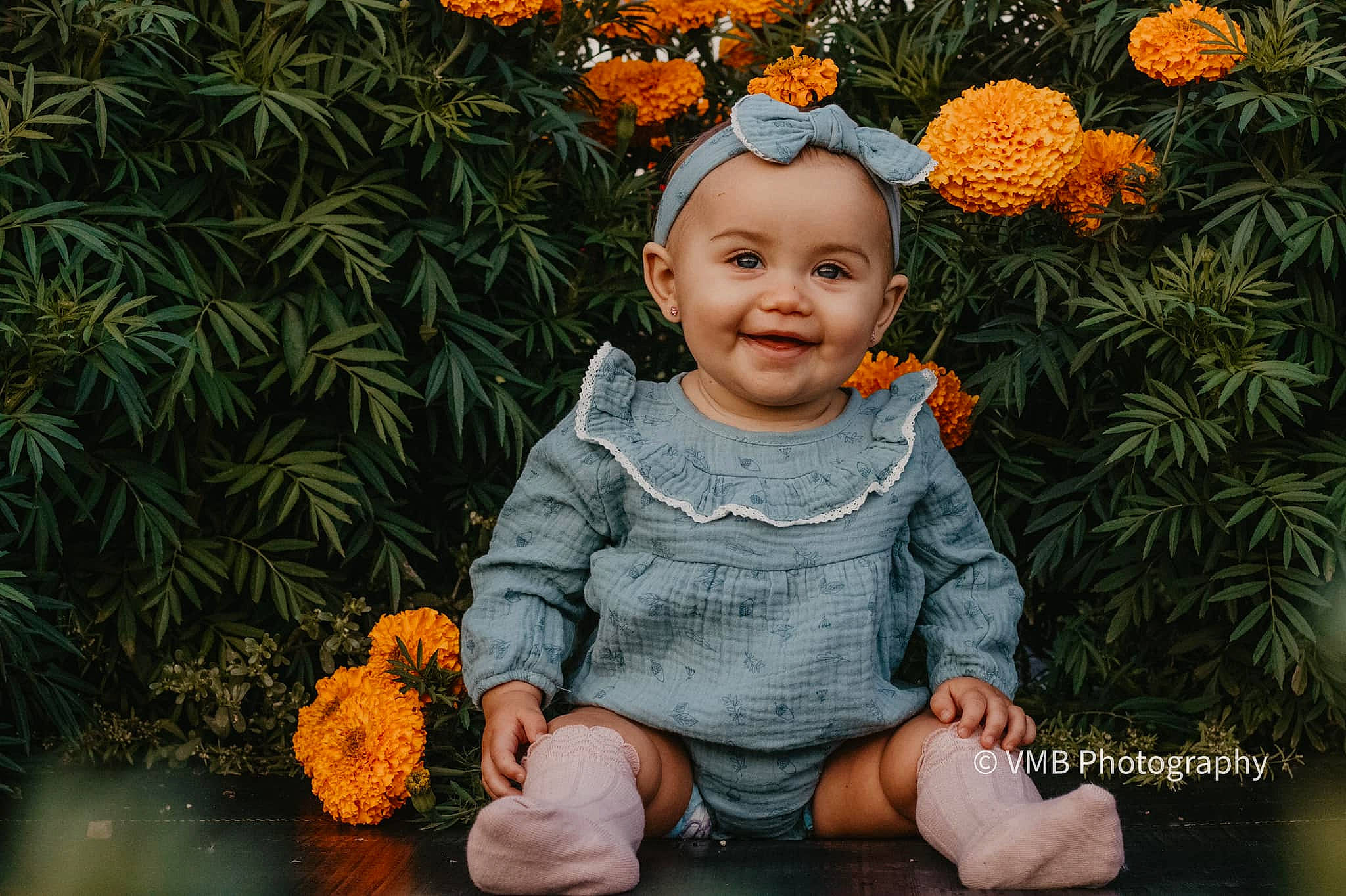 Avi is registered to the contest to win money with this photo: baby, baby_toddler_clothing, child, conifer, floral_design, flower, flowering_plant, fun, garden, grass, happy, headwear, joy, pattern, people_in_nature, person, petal, plant, rose_family, sitting