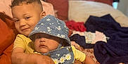 Eliana joined the competition — help win amazing prizes! child, baby, toddler, bed, blanket, pillow, denim, hat, hug, smile, family, indoor, clothing, hand, person, cute, floral, comfort, skin, affection