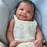 Tallulah is registered to the contest to win money with this photo: baby, bed, blanket, clothing, cushion, dress, face, furniture, happy, head, homedecor, knitwear, laughing, newborn, person, photography, portrait, sleeping, smile, sweater