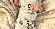 Rome is registered to the contest to win money with this photo: baby, infant, pacifier, hat, mouse_ears, disney, disney_characters, blanket, soft_texture, cute, clothing, sleepwear, lying_down, baby_girl, baby_boy, indoors, child, portrait, comfort, relaxation