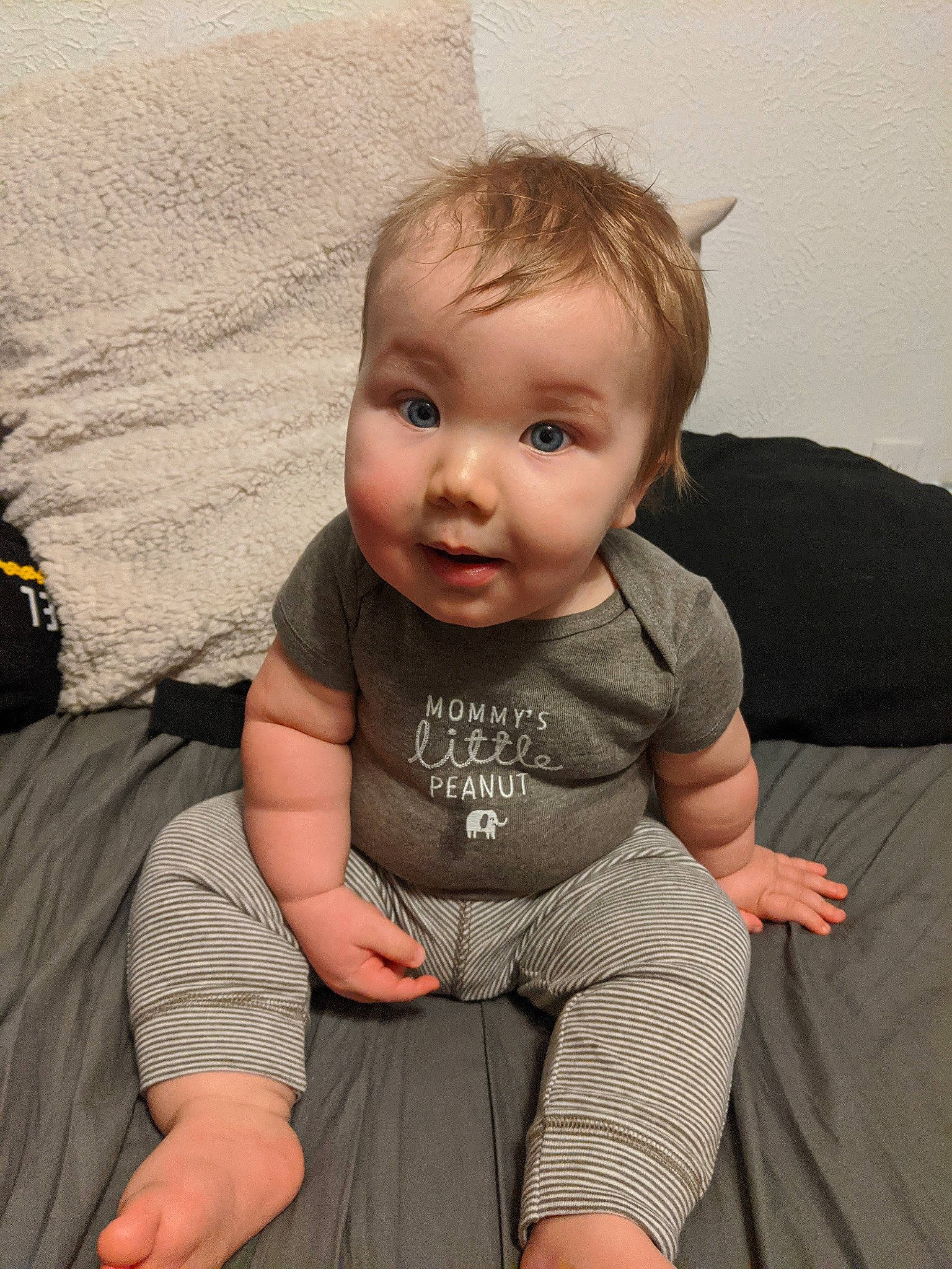 Huxton is registered to the contest to win money with this photo: arm, baby, cheek, child, chin, eye, face, head, leg, nose, person, sitting, skin, toddler, vacation