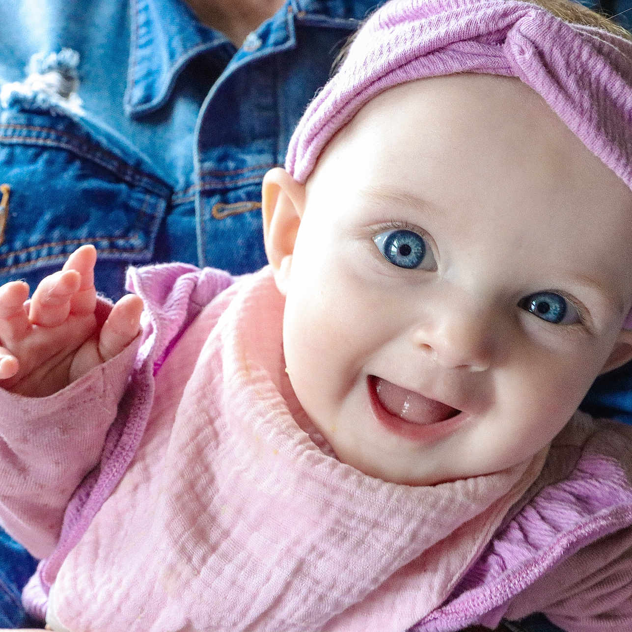 Rylynn joined the competition — help win amazing prizes! apparel, baby, blue_eyes, child, closeup, cute, denim_jacket, expression, face, fashion, happy, headband, human, indoor, infant, person, pink_clothing, portrait, smiling, waving_hand