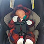 Theo is registered to the contest to win money with this photo: newborn, baby, car_seat, pacifier, sleeping, infant, clothing, mittens, footwear, safety, child, seatbelt, fabric, warm, cozy, indoor, warning_label, transportation, cute, resting