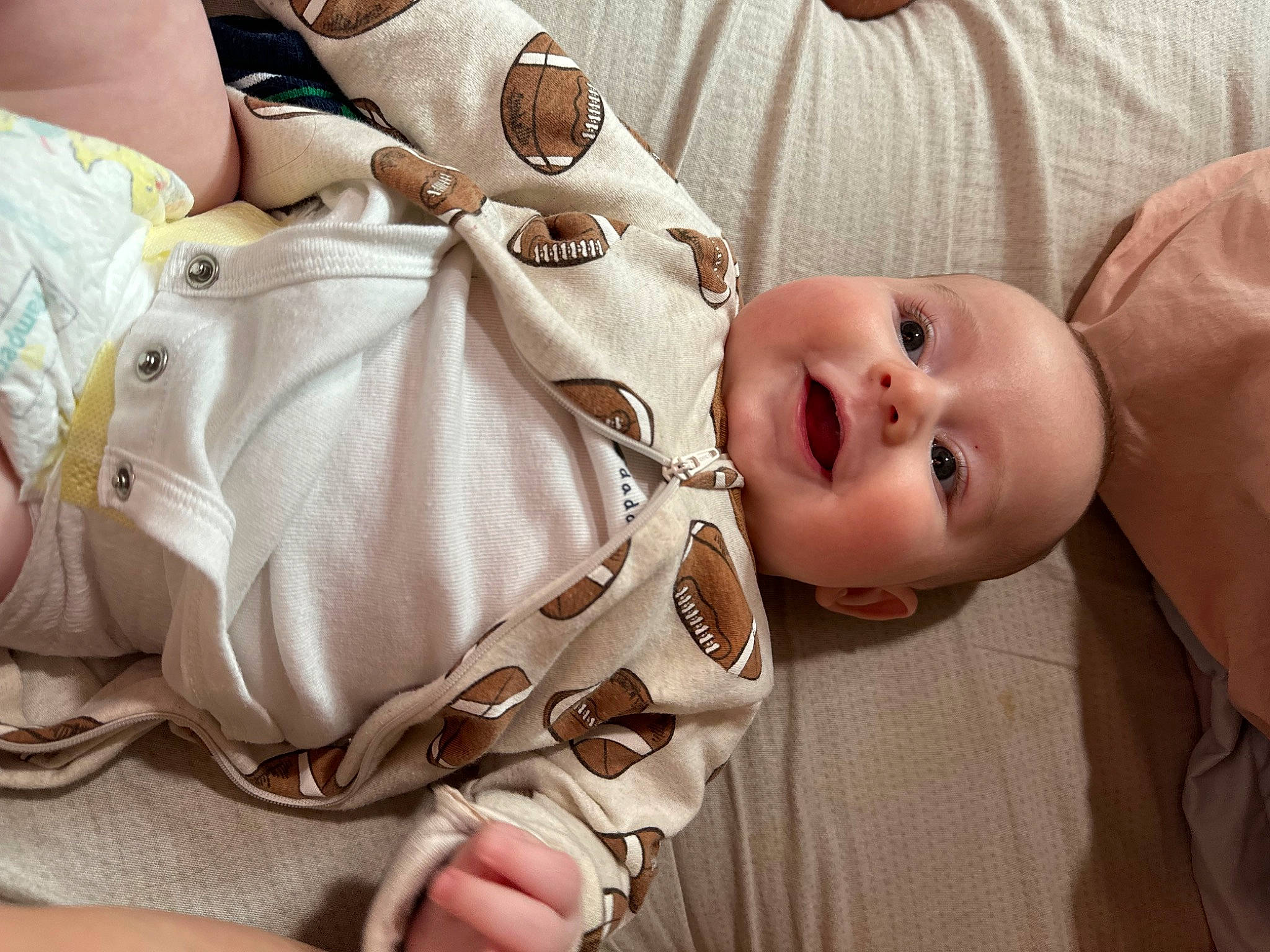 Xavier is registered to the contest to win money with this photo: baby, baby_products, baby_sleeping, baby_toddler_clothing, cheek, child, comfort, finger, happy, head, human_body, nail, pattern, person, skin, sleeve, smile, thumb, toddler, wood