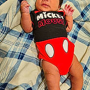 Armando joined the competition — help win amazing prizes! baby, infant, mickey_mouse, onesie, clothing, blanket, pattern, blue, white, red, skin, cute, lying_down, hand, face, person, newborn, soft, comfort, portrait
