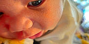 Armando joined the competition — help win amazing prizes! baby, close_up, face, skin, infant, soft_blanket, curious, child, young, cuteness, expression, warm_light, hair, resting, intimate, portrait, fingers, clothing, comfort, indoor