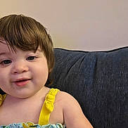 Haley joined the competition — help win amazing prizes! toddler, child, smiling, face, hair, yellow_clothing, patterned_clothing, couch, indoor, portrait, cute, baby, person, sitting, young_child, happy, skin, head, shoulder, background