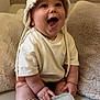 Giulio participe au concours pour gagner de l'argent avec cette photo : baby, infant, smiling, hat, clothing, shoes, couch, plush, pillow, happy, indoors, child, sitting, cute, person, soft_texture, comfortable, home, portrait, toddler