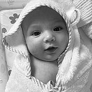 Raya joined the competition — help win amazing prizes! baby, infant, towel, hooded_towel, face, eyes, hand, skin, portrait, cute, expression, newborn, child, soft_texture, wrapped, close_up, indoor, monochrome, black_and_white, smile