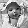 baby, infant, towel, hooded_towel, face, eyes, hand, skin, portrait, cute, expression, newborn, child, soft_texture, wrapped, close_up, indoor, monochrome, black_and_white, smile