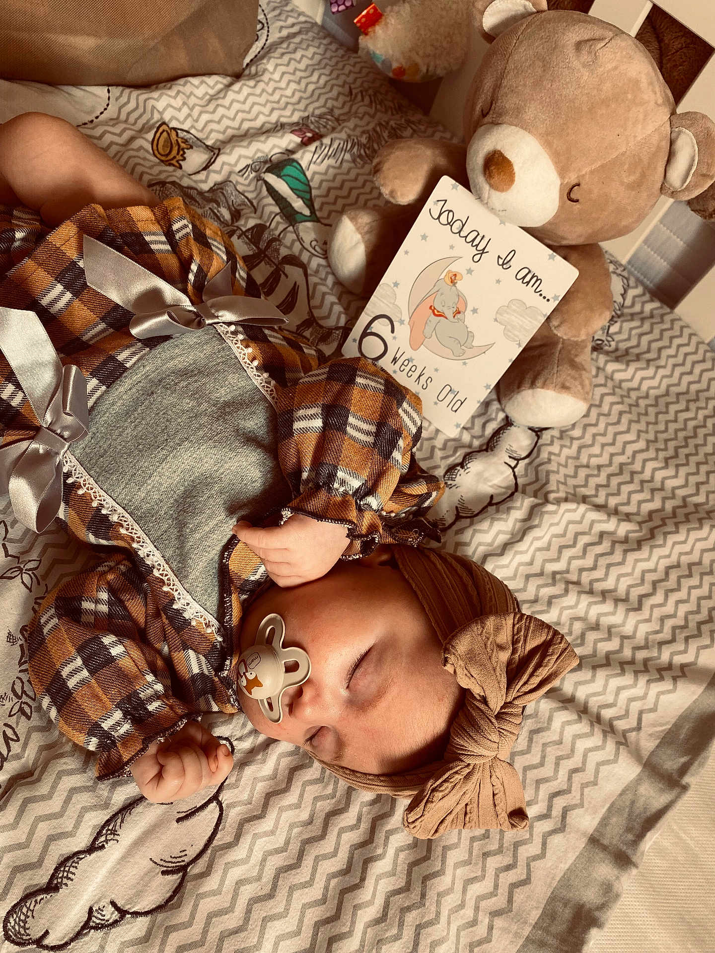 Raya joined the competition — help win amazing prizes! baby, sleeping, pacifier, headband, bow, teddy_bear, plush_toy, blanket, patterned_blanket, cute_outfit, checkered, infant, child, lying_down, indoors, soft_toys, card, 6_weeks_old, peaceful, nap