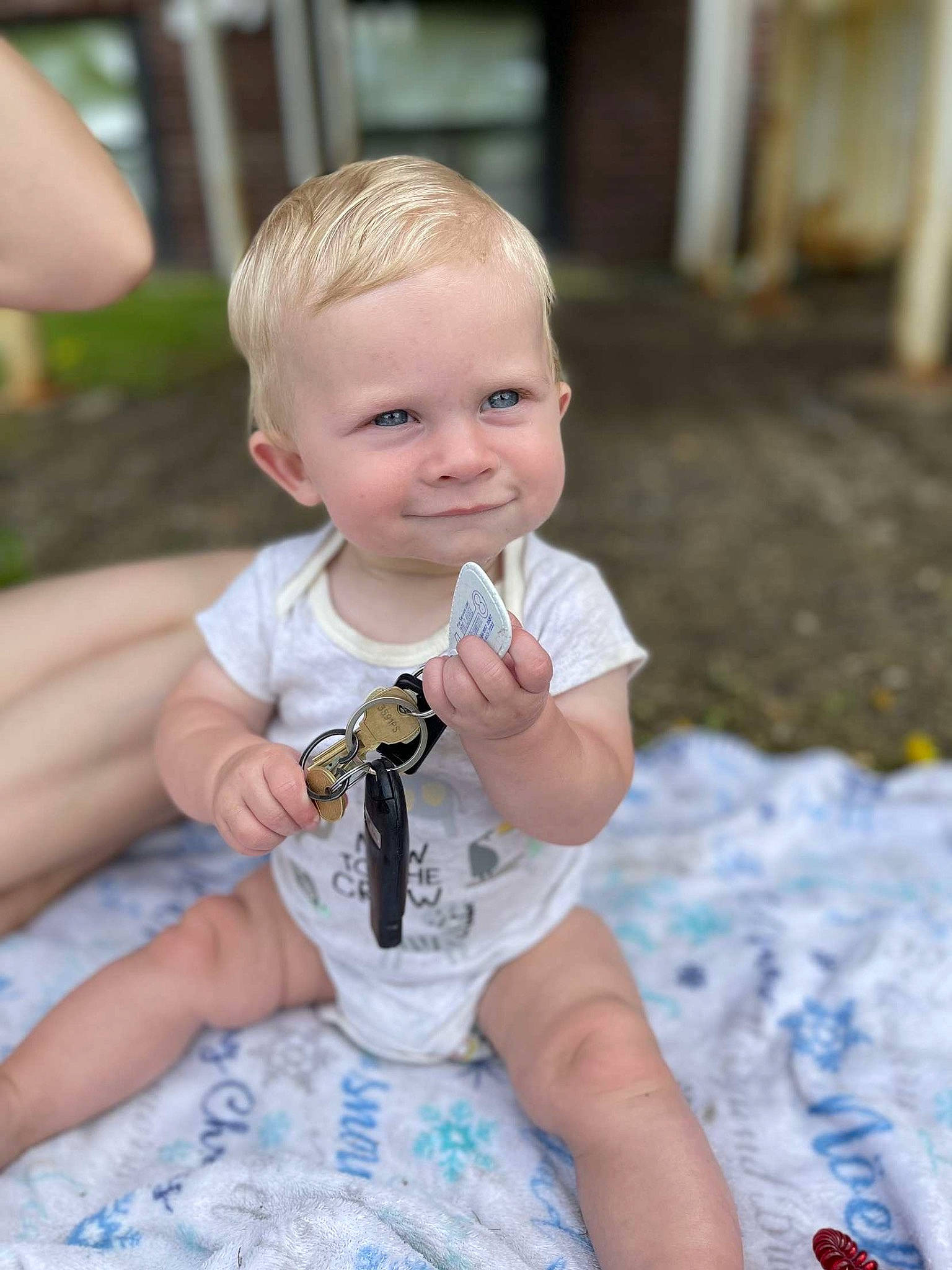 Gavin is registered to the contest to win money with this photo: baby, baby_toddler_clothing, blond, cheek, child, eye, face, fun, grass, happy, head, joy, leisure, person, play, recreation, sitting, skin, sleeve, smile
