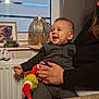 Adam participe au concours pour gagner de l'argent avec cette photo : baby, child, smiling, indoor, adult, hand, window, curtain, lamp, decor, clothing, toy, face, person, holding, radiator, table, happy, seated, cozy