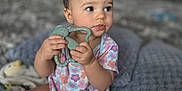 Madison is registered to the contest to win money with this photo: baby, blanket, carpet, child, chubby_cheeks, curious, cute, expression, floral_pattern, foot, hand, head, home, indoor, infant, onesie, portrait, sitting, soft_toys, teething_toy