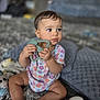 Madison is registered to the contest to win money with this photo: baby, child, teething_toy, onesie, floral_pattern, carpet, soft_toys, blanket, indoor, cute, infant, sitting, chubby_cheeks, curious, expression, hand, foot, head, portrait, home