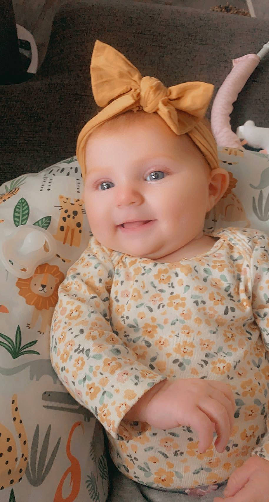 Kassidy is registered to the contest to win money with this photo: baby, baby_toddler_clothing, cheek, child, dress, eye, facial_expression, happy, human_body, iris, lip, pattern, peach, person, pink, product, skin, sleeve, smile, textile