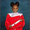 child, graduation, gown, diploma, cap, smile, portrait, studio, happy, celebration, education, young, person, red_clothing, background, posing, hair_style, ribbons, formal, achievement
