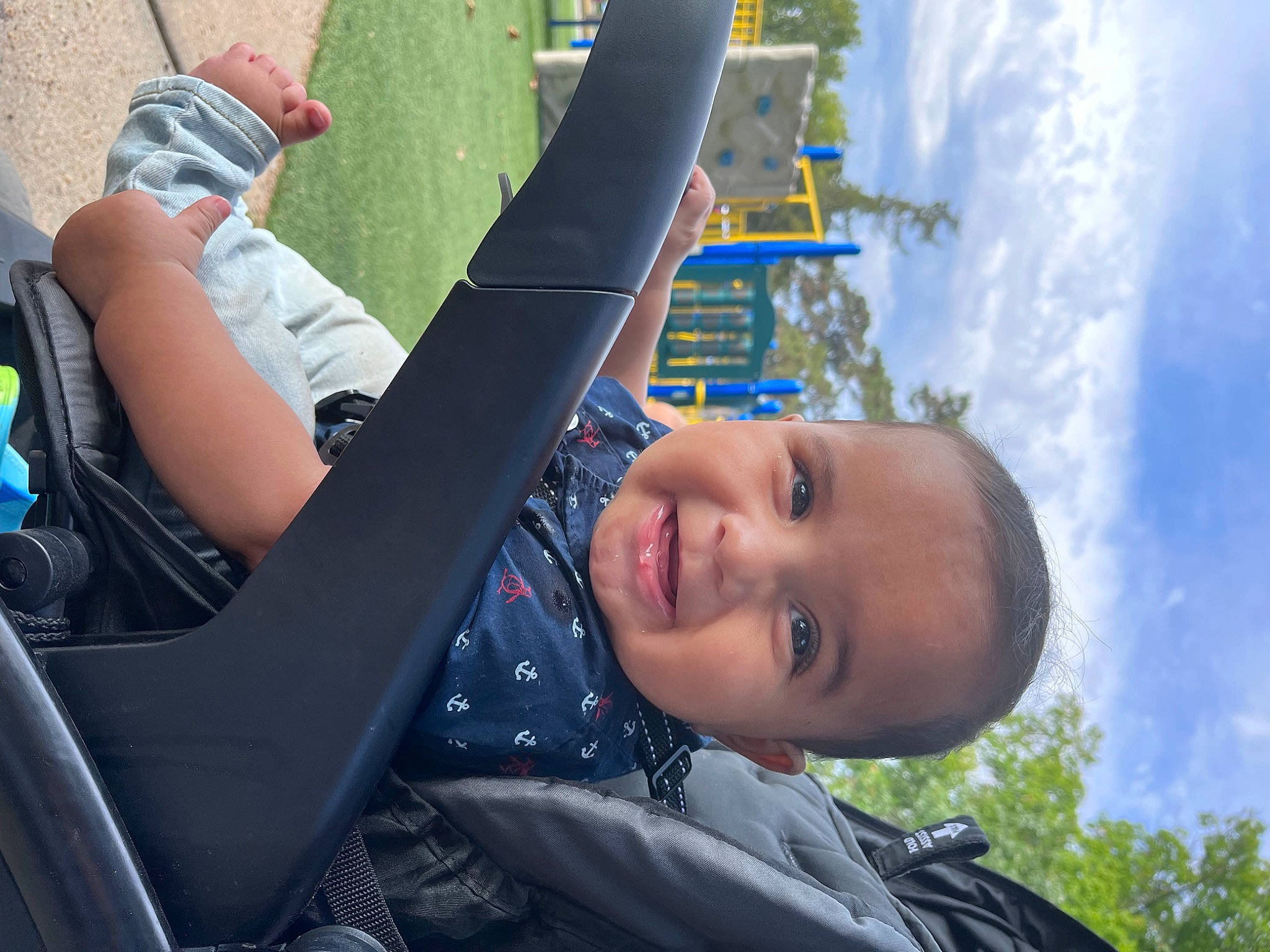 Taron Jr is registered to the contest to win money with this photo: automotive_exterior, child, city, cloud, family_car, fun, grass, happy, joy, laugh, leisure, outdoor_play_equipment, person, personal_protective_equipment, recreation, sky, smile, swing, toddler, travel