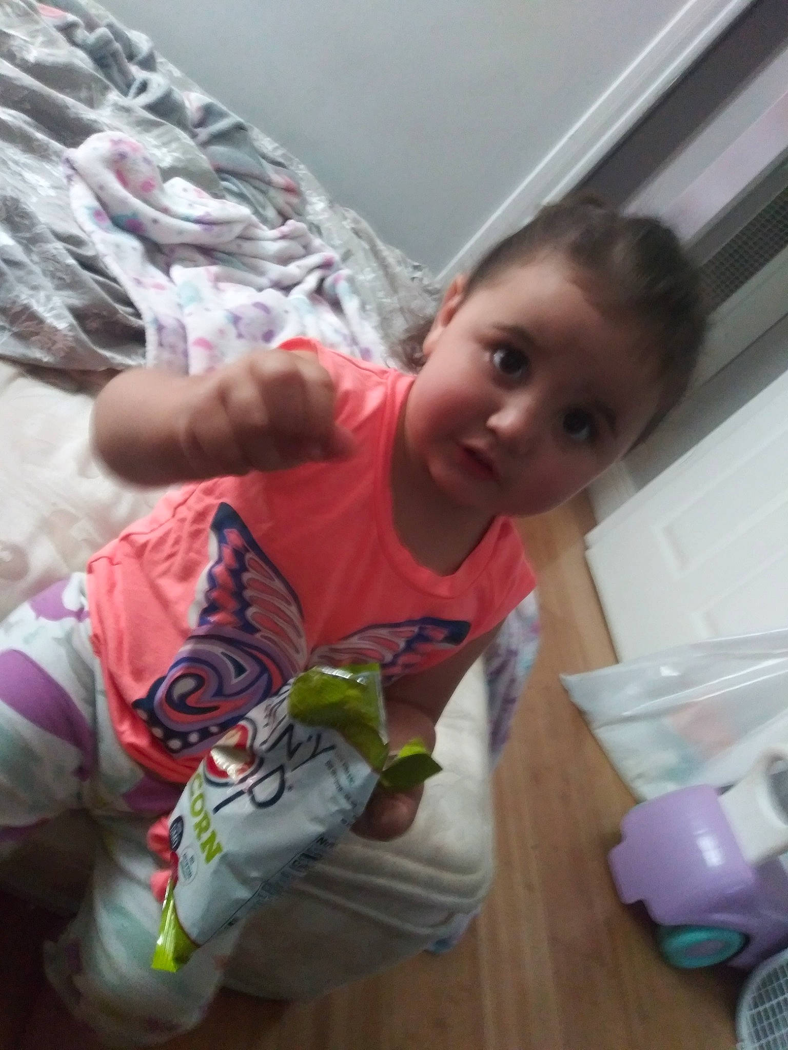 Malayah is registered to the contest to win money with this photo: baby, carmine, child, comfort, flooring, fun, happy, linens, paper_towel, pattern, person, plastic, plastic_bottle, play, room, sitting, sleeve, t_shirt, toddler, toy