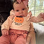 Amelia is registered to the contest to win money with this photo: baby, infant, child, cute, pumpkin, headband, bow, pink_clothing, sitting, couch, window, hand, indoor, person, face, autumn, soft_lighting, cozy, portrait, home