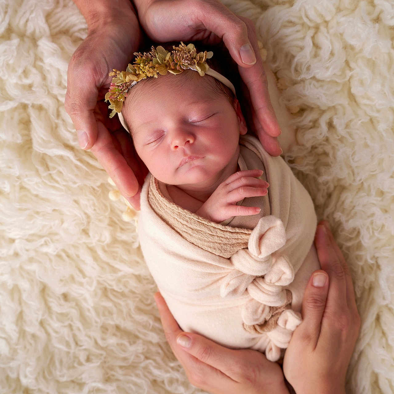 Luna participe au concours pour gagner de l'argent avec cette photo : newborn, baby, sleeping, hands, flower_headband, blanket, swaddled, soft_texture, white_background, closeup, portrait, infant, tenderness, care, family, peaceful, rest, skin, adult_hands, comfort