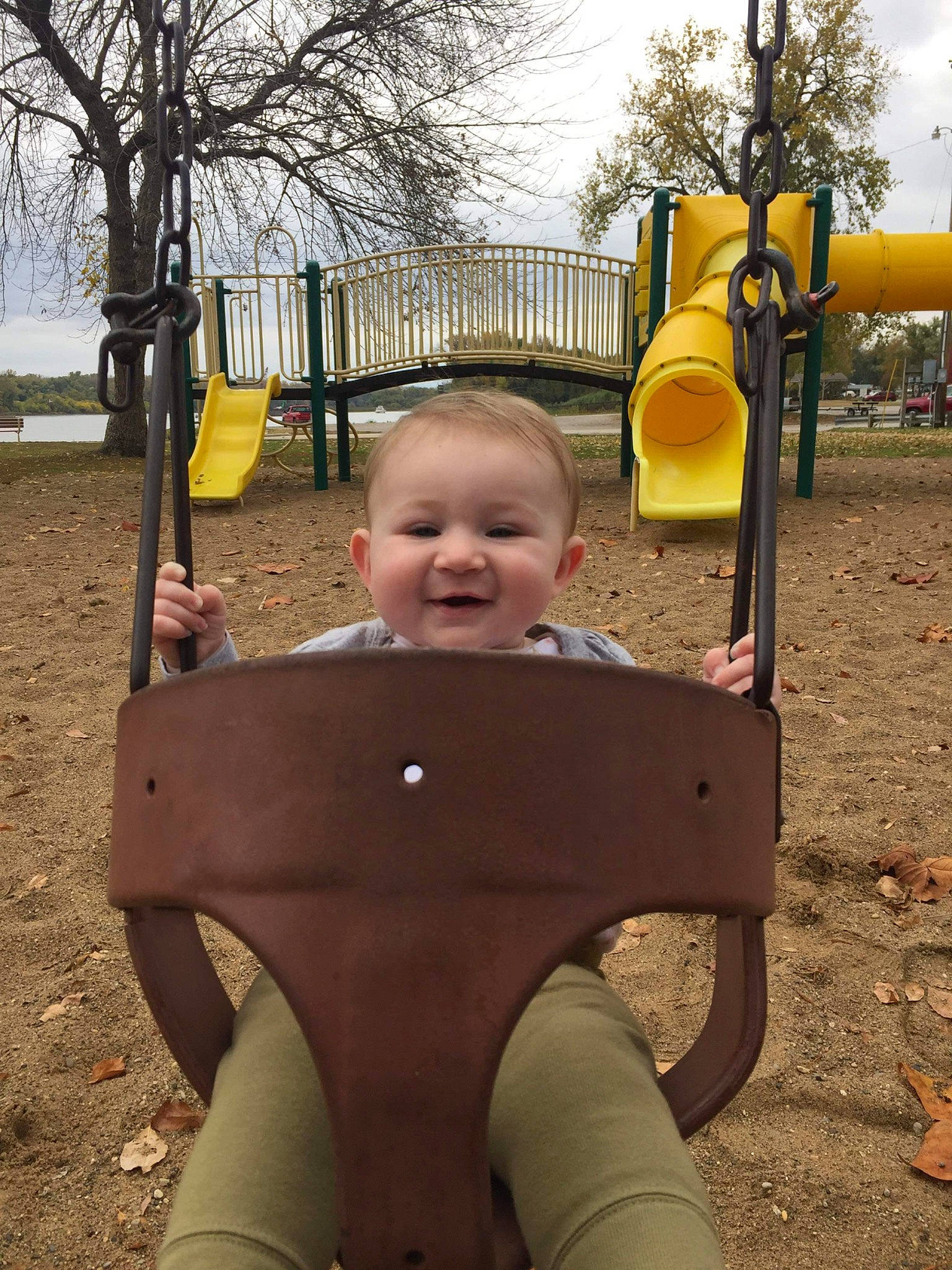 Juniper is registered to the contest to win money with this photo: baby, child, city, eye, fun, grass, happy, joy, leisure, outdoor_play_equipment, people, people_in_nature, person, photograph, plant, playground, public_space, smile, toddler, tree