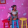 barstool, chair, child, clothing, diningtable, face, female, footwear, furniture, girl, head, indoors, person, photography, portrait, purple, shoe, shorts, sitting, table