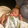 baby, blanket, bear_pattern, sleeping, thumb_sucking, infant, person, arm, cozy, soft_texture, cute, resting, comfort, child, toddler, peaceful, holding, fabric, closeup, portrait