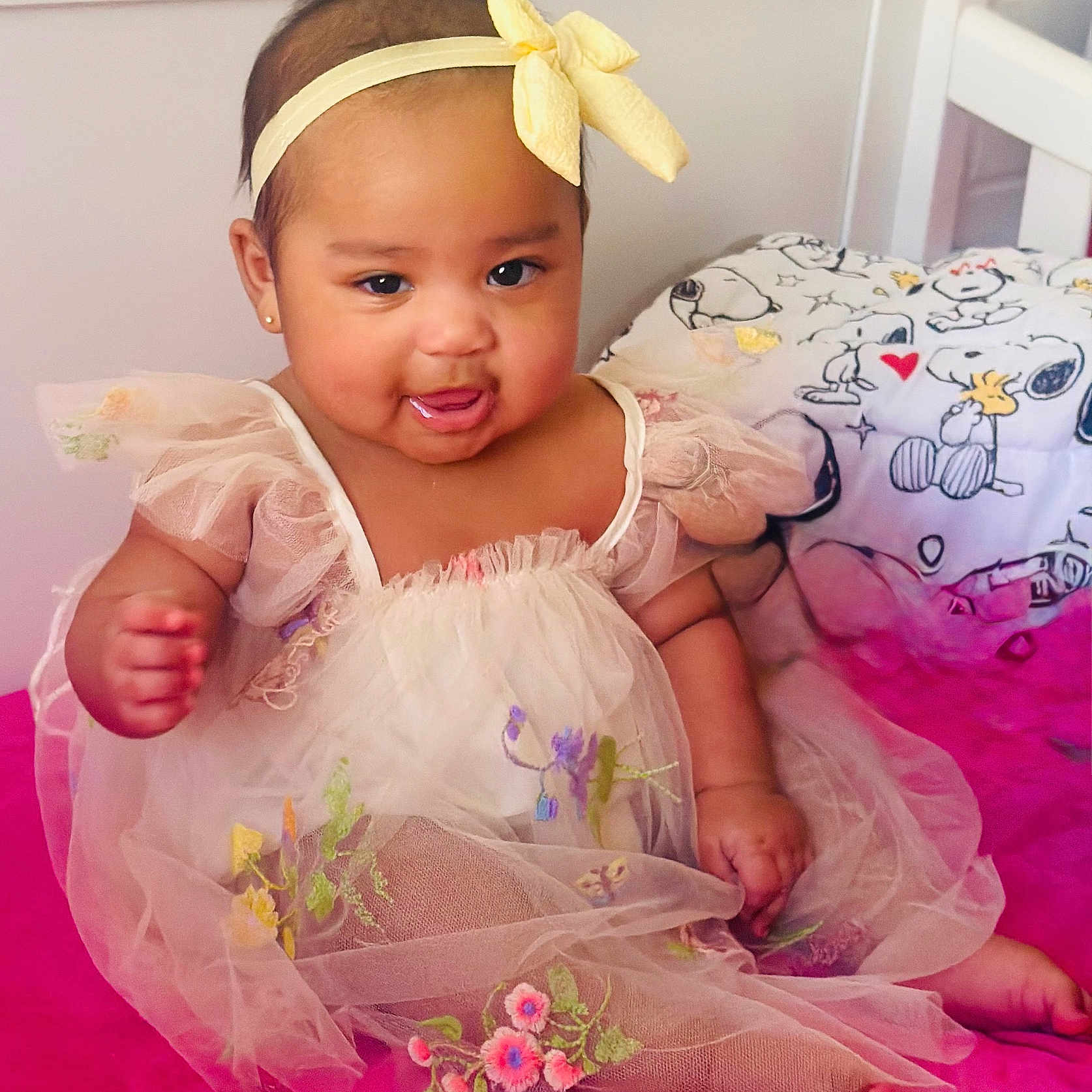 Florencia joined the competition — help win amazing prizes! adorable, baby, bedding, bedroom, cartoon, child, cute, dress, drool, happy, headband, indoors, infant, pink_surface, portrait, sitting, smile, snoopy, tulle, yellow_bow