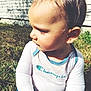 baby, casual, child, clothing, daylight, face, grass, hair, head, nature, outdoor, person, portrait, shirt, side_profile, sitting, skin, sunlight, toddler, young_child
