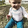 casual, child, clothing, curious, daylight, expression, face, grass, house, long_sleeve, nature, outdoor, pants, person, playing, shirt, sitting, smile, toddler, young_child