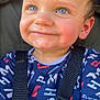 baby, blue_eyes, child, close_up, clothing, cute, expression, face, happy, harness, indoors, patterned_shirt, person, portrait, rosy_cheeks, seat, smile, straps, toddler, young_child