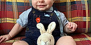 Johnny joined the competition — help win amazing prizes! baby, plush_toy, bunny, couch, plaid, child, smiling, blue_eyes, shorts, striped_shirt, indoor, seated, cute, toy, soft_toy, button, fabric, pattern, happy, person