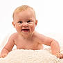 Nansi is registered to the contest to win money with this photo: baby, smile, blue_eyes, blanket, fluffy, cute, infant, skin, happy, face, child, portrait, cheeks, hands, crawling, soft, light, studio, expression, naked_shoulders