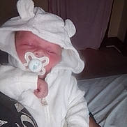 Zeppelin joined the competition — help win amazing prizes! baby, infant, pacifier, white_clothing, hooded_onesie, sleeping, cute, hand, arm, person, indoors, bed, blanket, soft_texture, cozy, newborn, resting, child, toddler, cute_outfit