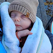 Brantley joined the competition — help win amazing prizes! baby, sleeping, blanket, hat, knitted_hat, cozy, cute, child, infant, outdoor, warm, soft, face, hands, person, closeup, peaceful, wrapped, winter, adorable