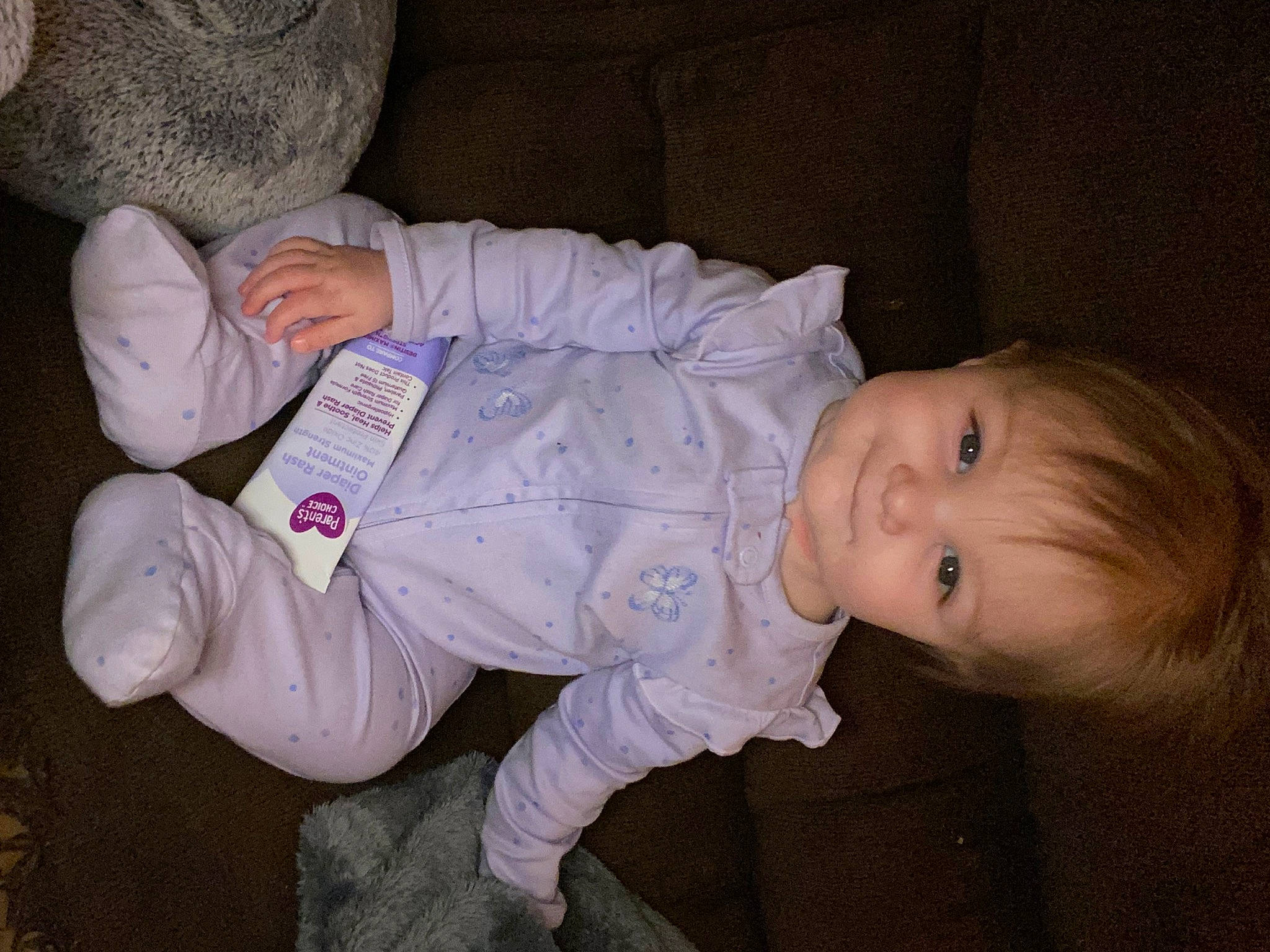 Elliana is registered to the contest to win money with this photo: baby, baby_products, baby_toddler_clothing, cheek, child, comfort, eye, facial_expression, finger, head, iris, mouth, nose, person, product, sitting, skin, sleeve, thumb, toddler